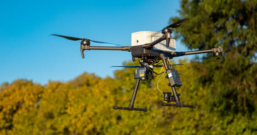 Agricultural drone flying above cultivated fields