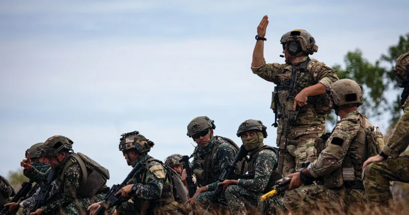 Soldiers gathered outdoors with communications equipment